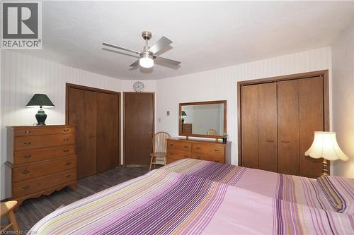 Ceiling fan with integrated lighting, wood-finish flooring, and multiple flush-panel closet doors - 185 Southwood Drive, Kitchener, ON 