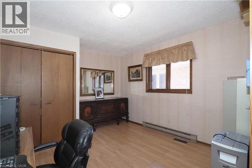 Light wood-finish flooring, flush mount ceiling light, and double-door closet - 185 Southwood Drive, Kitchener, ON 