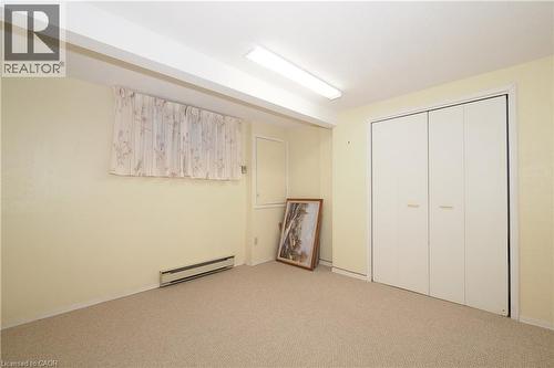 Carpeted room featuring light-colored walls and a bi-fold closet - 185 Southwood Drive, Kitchener, ON 