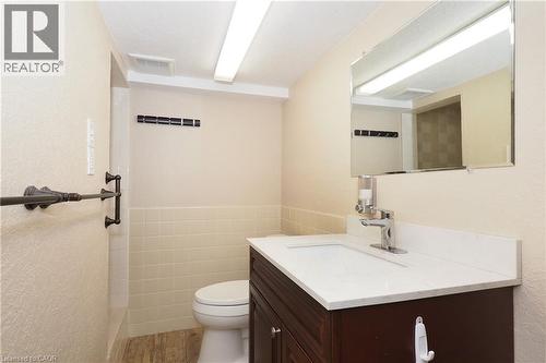Dark wood-finish vanity with white countertop and integrated sink - 185 Southwood Drive, Kitchener, ON 