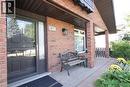 Brick exterior with covered entry, paver patio, and exterior lighting - 185 Southwood Drive, Kitchener, ON 