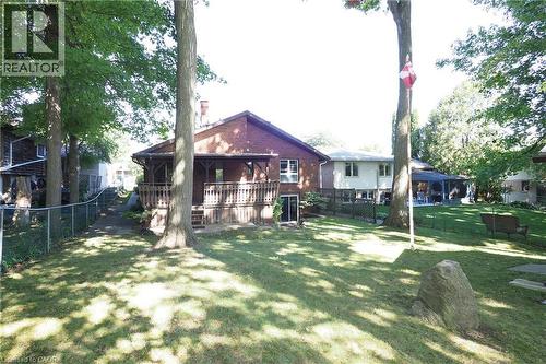 Expansive lawn with mature trees and a chain-link fence - 185 Southwood Drive, Kitchener, ON 
