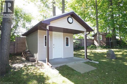 Shed with light-toned siding, covered entry, and a concrete ramp - 185 Southwood Drive, Kitchener, ON 