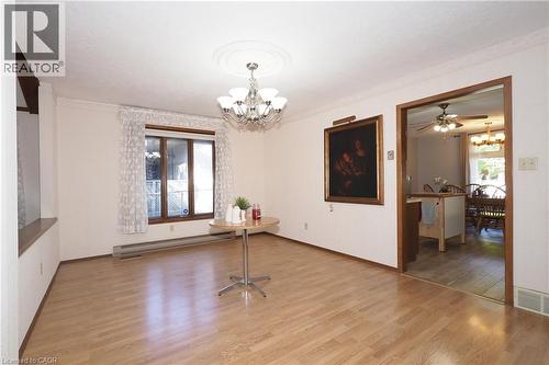 Recessed window with wood-finish trim, wood-finish flooring, and crown molding - 185 Southwood Drive, Kitchener, ON 