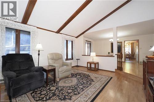 Vaulted ceiling with exposed wood beams, wood-finish flooring, and natural light from multiple windows - 185 Southwood Drive, Kitchener, ON 