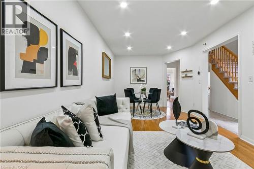 Recessed lighting illuminates the white walls and wood-finish flooring - 1373 Quest Circle, Mississauga, ON 
