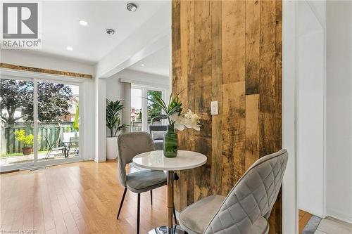 Hardwood flooring, recessed lighting, sliding glass door, and a distressed wood-paneled feature wall - 1373 Quest Circle, Mississauga, ON 