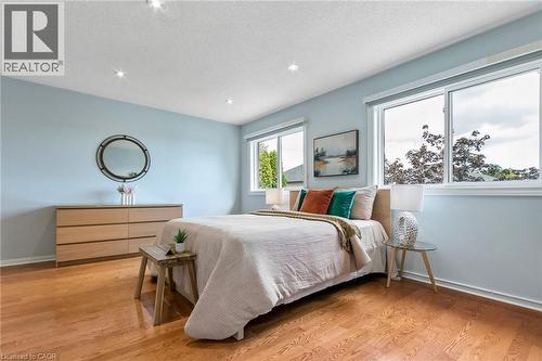 Recessed lighting, wood-finish flooring, and multiple windows with white trim - 1373 Quest Circle, Mississauga, ON 