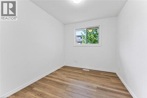 Bedroom #1 with new flooring, window and closet - 21 Vicmount Drive, Kitchener, ON 