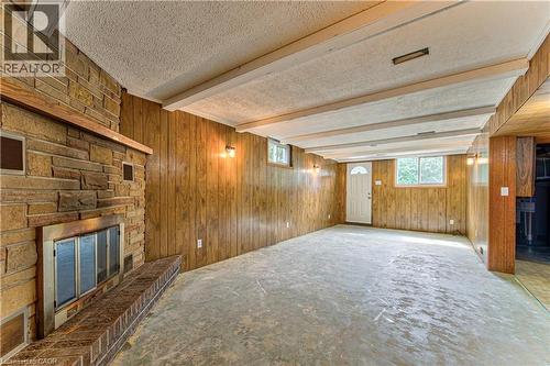 Recreation room ready for new flooring with walkout to rear patio area. - 21 Vicmount Drive, Kitchener, ON 