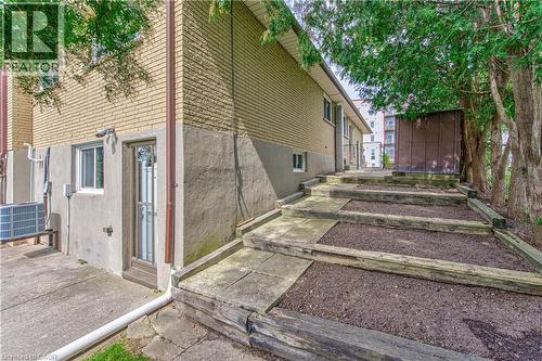 Stairs leading to rear patio and deep fenced yard - 21 Vicmount Drive, Kitchener, ON 