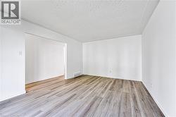 Spacious Living room with new wide vinyl plank flooring - 