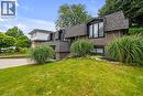 Split-level exterior with dark shingles and brown siding - 4236 Longmoor Drive, Burlington, ON 