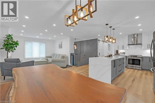 Open-concept living space with recessed lighting, wood-finish flooring, and a modern kitchen - 4236 Longmoor Drive, Burlington, ON 
