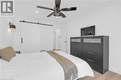 Recessed lighting, wood-finish flooring, and a contemporary ceiling fan with integrated lighting - 4236 Longmoor Drive, Burlington, ON 