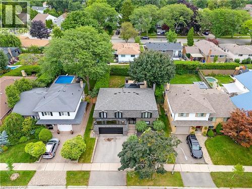 Contemporary residence featuring a paved driveway, attached garage, and mature landscaping - 4236 Longmoor Drive, Burlington, ON 