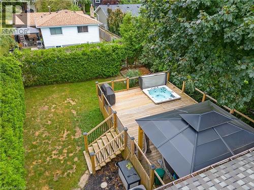 Expansive backyard featuring a multi-level wood deck, built-in hot tub, and a shaded gazebo - 4236 Longmoor Drive, Burlington, ON 