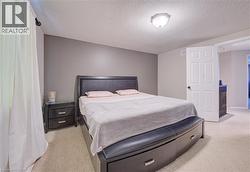 Carpeted flooring throughout, overhead lighting fixture, and a neutral color palette - 