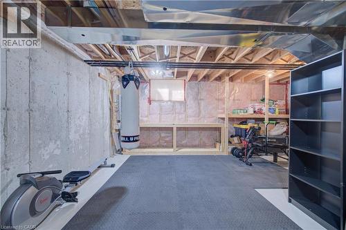 Unfinished basement with concrete walls, exposed ceiling joists, and visible ductwork - 300 Fallowfield Drive Unit# 21, Kitchener, ON 