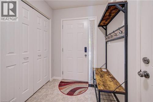 Entryway with a paneled white door, sidelight, and tiled flooring - 300 Fallowfield Drive Unit# 21, Kitchener, ON 