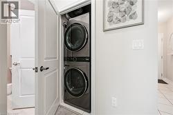 Stacked laundry appliances within a dedicated closet - 