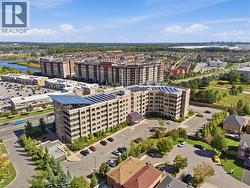 Contemporary multi-story building featuring a stone and panel exterior, solar panel roof installation, and an integrated covered entry - 