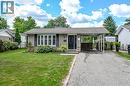 Brick exterior with a prominent bay window, attached carport, and a paved driveway - 1434 Dewbourne Crescent, Burlington, ON 