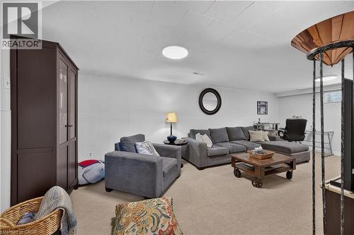 Recessed ceiling lighting, white wainscoting, light-colored carpeting, and a built-in dark wood storage cabinet - 1434 Dewbourne Crescent, Burlington, ON 