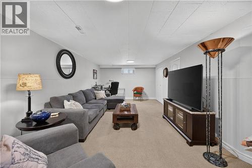 Carpeted flooring, light gray walls with white wainscoting, and a drop panel ceiling - 1434 Dewbourne Crescent, Burlington, ON 