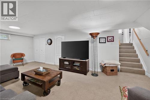 Carpeted flooring, bi-fold closet doors, white paneled doors, and a round overhead light fixture - 1434 Dewbourne Crescent, Burlington, ON 