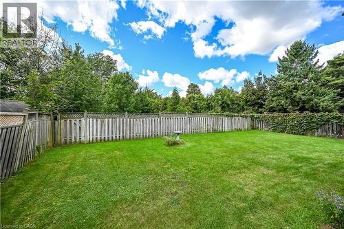 Expansive grass yard with wood fencing and mature perimeter trees - 1434 Dewbourne Crescent, Burlington, ON 