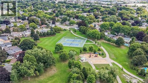 Expansive green space featuring multiple tennis courts, a children's play area, and paved walking paths - 1434 Dewbourne Crescent, Burlington, ON 