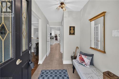Entry foyer featuring tile flooring, a decorative front door with leaded glass inserts, and a flush-mount ceiling light fixture - 1434 Dewbourne Crescent, Burlington, ON 