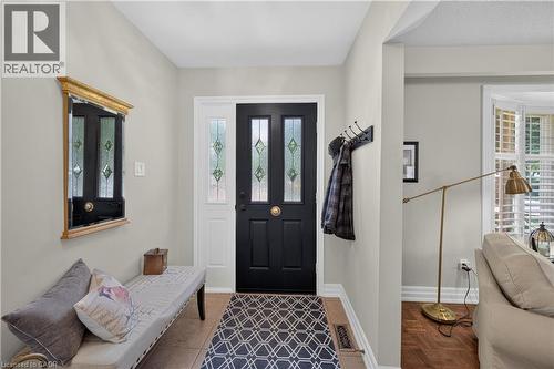 Entryway featuring a black door with decorative glass inserts, a white sidelight, and neutral wall tones - 1434 Dewbourne Crescent, Burlington, ON 