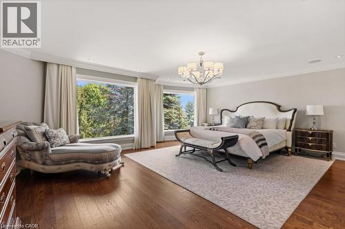 Hardwood flooring, crown molding, recessed lighting, and a chandelier with ambient lighting - 4038 Lakeshore Road, Burlington, ON 