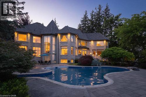Stone exterior with a turret feature and multiple large windows - 4038 Lakeshore Road, Burlington, ON 