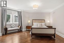 Hardwood flooring, crown molding, double window with trim, ceiling-mounted light fixture - 