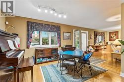 Hardwood flooring, track lighting, and a built-in media console - 