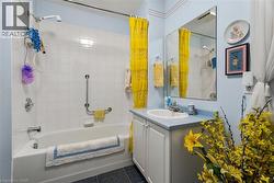White tiled shower and bathtub combination with chrome fixtures - 