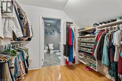 Wood-finish flooring with built-in closet shelving and hanging rods - 