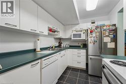 White cabinetry, dark countertops, and dark floor tiles - 