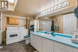 White vanity with integrated sink, light blue countertop, and full-width mirror - 