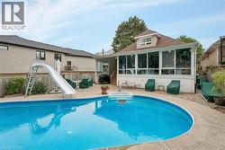 In-ground swimming pool with integrated steps, surrounded by a paved patio - 