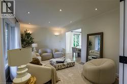 Recessed lighting, crown molding, large windows, wall sconces, and wood-finish flooring - 