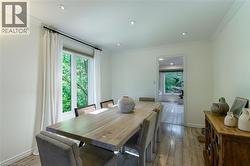 Recessed lighting, crown molding, wood-finish flooring, and a large window - 