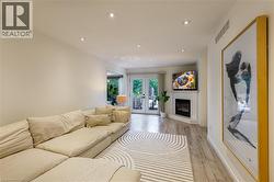 Recessed ceiling lighting, light wood-finish flooring, and white walls - 