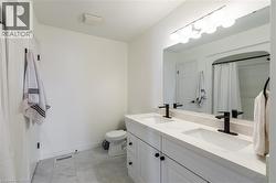 Dual vanity with integrated sinks, matte black fixtures, and a spacious mirror - 