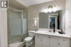 White vanity with an integrated rectangular sink, stone-finish countertop, and brushed nickel fixtures - 
