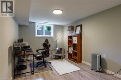 Recessed window, wood-finish flooring, built-in shelving, and a flush-mount ceiling light fixture - 
