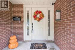 Brick exterior with a white entry door, side lites, and a black mailbox - 